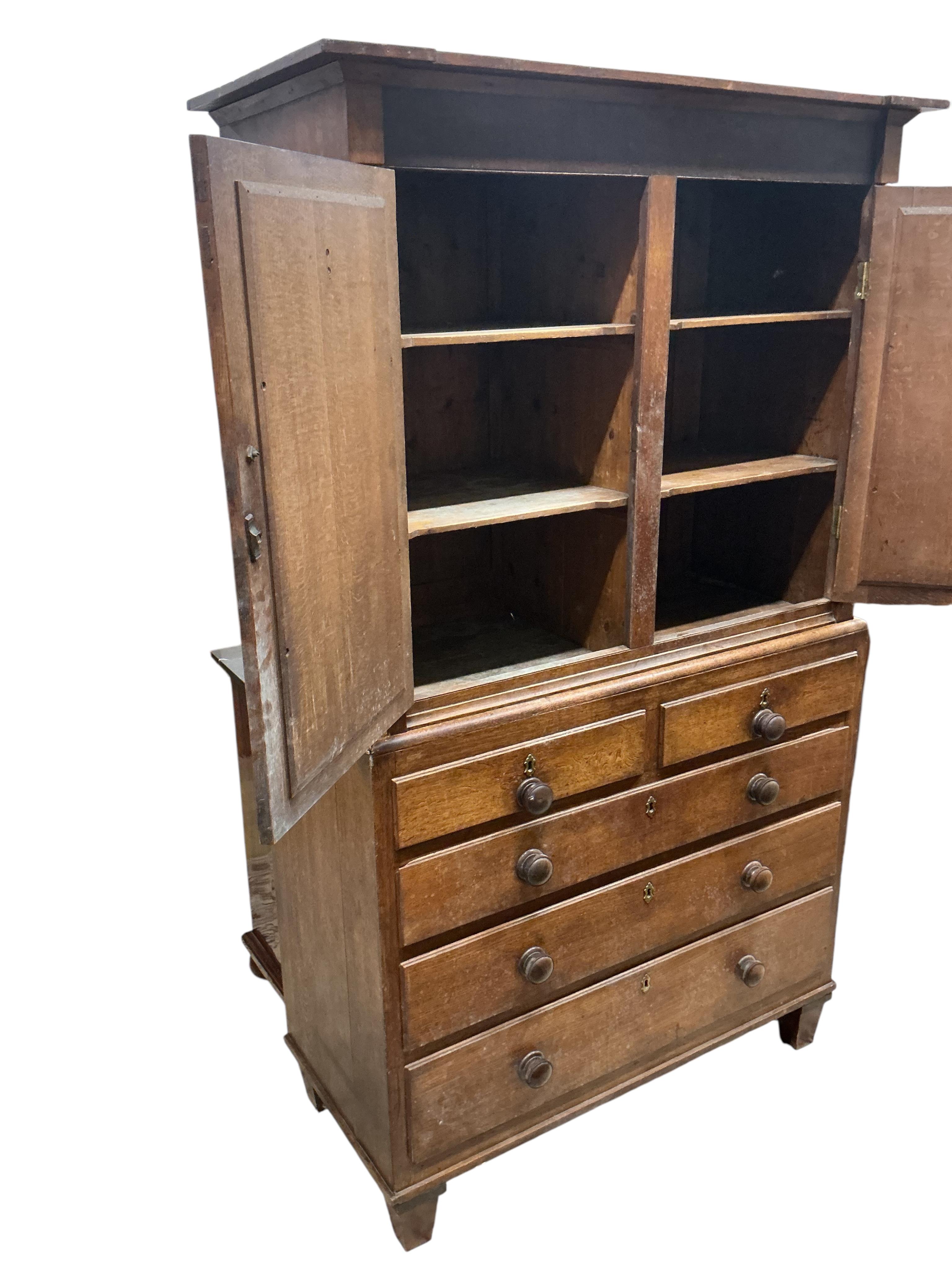 A 19th century oak press cupboard, width 117cm, depth 54cm, height 198cm